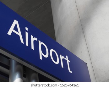 Airport street sign in white over blue
