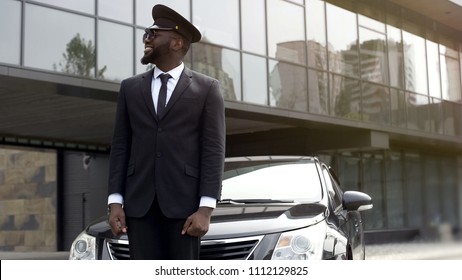 Airport Taxi Driver Waiting For Client Arrival, Transfer Service At Luxury Hotel