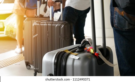 Airport Taxi. Passenger With Big Roller Luggage Standing On The Line Waiting For Taxi Queue At Taxi Parking Lot At Airport Arrival Terminal