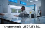 Airport Terminal: African American Security Officer Monitors Baggage Screening on Computer Screens. People Putting Personal Items in Trays for Scanning, Passing Trough Metal Detector Scanner Gates.