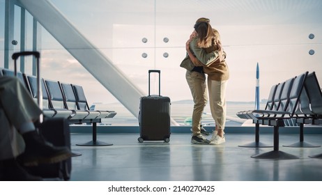 Airport Terminal Family Reunion: Beauitful Couple Meets at the Boarding Lounge. Smiling Girlfiend Meets the Love of Her Life after Long Parting and Hugs and Dances with Her Handsome Partner - Powered by Shutterstock