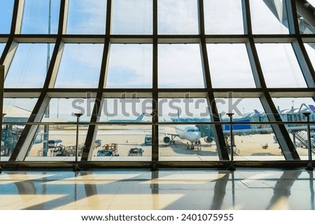 Airport terminal glass window with view of airplane, Suvarnabhumi airport departure hall for travel and transportation concept.