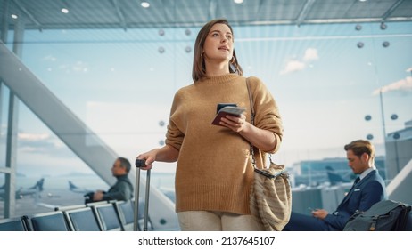 Airport Terminal: Happy Traveling Caucasian Woman Waiting at Flight Gates for Plane Boarding, Uses Mobile Smartphone, Checking Trip Destination on Internet. Smiling White Female on Vacation Trip - Powered by Shutterstock