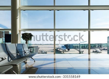 Airport terminal, people going to airplane in background