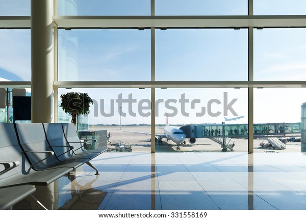 Airport\
terminal, people going to airplane in\
background