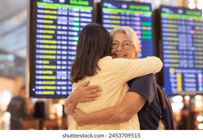 Airport terminal reunion. Travel, friends, family hug in airport, reunion and happiness for international trip, getaway and cheerful. Love, women couple embrace for arrival or departure trip - Powered by Shutterstock