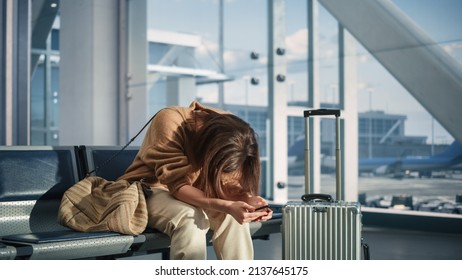 Airport Terminal: Woman Waits for Flight, Uses Smartphone, Receives Bad News, Starts Crying. Upset, Sad, and Dissappointed Person Misses Her Flight while Sitting in a Boarding Lounge of Airline Hub.