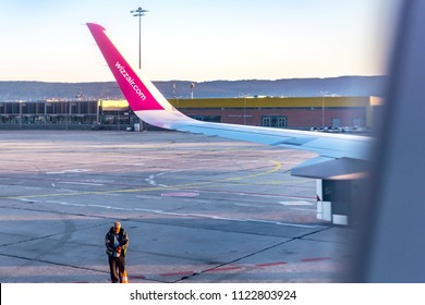 Airport Varna, Bulgaria - 21.06.2018. View from the window of an airplane flying to Cyprus in the early morning Golden Hour. Airplane wing of Wizzair and aircraft ladders.