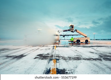 Airport in winter. Deicing of the airplane before flight.