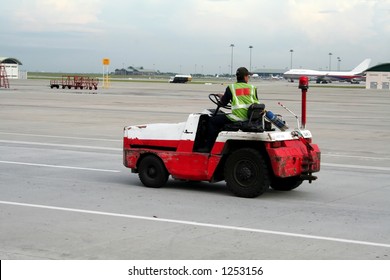 Airport Worker On A Vehicle, Racing Down The Runway