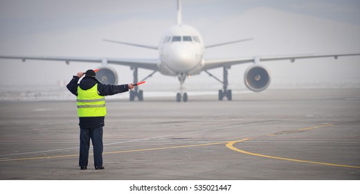 airport worker signaling