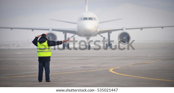 airport worker\
signaling