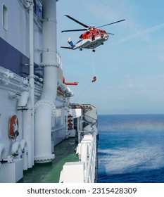 Air-sea rescue operations. Red rescue helicopter and Oil Tanker Ship . rescue team. The Coast security. The accident on the water. Ship have Emergency Accident. Training air sea recue operations.  - Shutterstock ID 2315428309