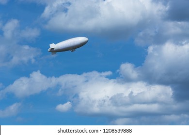 Airship, Zeppelin Against Blue Sky With Dark Clouds.