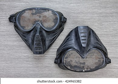 Airsoft BB gun metal mesh mask, Face safety protection from shooting sport game,  Terrorist look mask on wood background.. (Grunge Effect Process) 