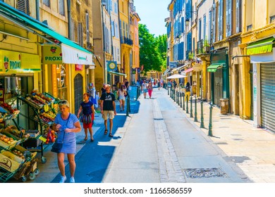 AIX-EN-PROVENCE, FRANCE, JUNE 18, 2017: People are strolling through a narrow street in the center of Aix-en-Provence, France