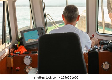 Ajaccio, France - July 2, 2015: Captain Of A Tug Boat Enters The Port Of Ajaccio, Rear View