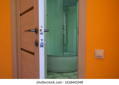 Ajar Door To The Bathroom With Shower. The Problem Of Privacy. Close-up