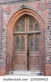 Ajar Wooden Door Of A Neo-Gothic Post Office In Inowrocław, Poland