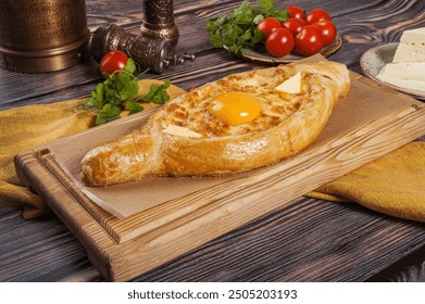 Ajarian Khachapuri, filled with cheese and topped with egg yolk, traditional Georgian Khachapuri 