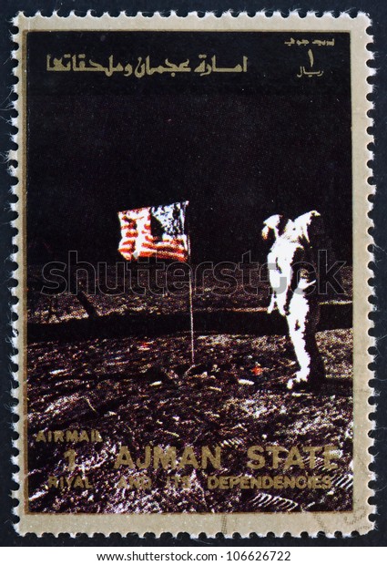 AJMAN - CIRCA 1973: a stamp printed in the\
Ajman shows Edwin Buzz Aldrin Salutes U.S. Flag on the Lunar\
Surface, Moon-landing, Apollo 11, circa\
1973
