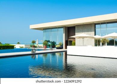 Ajman, United Arab Emirates - 30 October 2018: Landscape with modern design buildings, lagoon pool and garden in a luxury hotel in Al Zorah coastline  - Shutterstock ID 1226091292