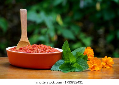 Ajvar-Serbian Sauce In A Dish Arranged With Nettle And Flowers, Popular In The Western Balkans