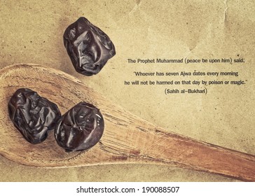 Ajwa Dates fruit on wooden spoon in retro style (Ajwa is a soft dry variety of date fruit from Saudi Arabia. It is cultivated at the city of Madinah)