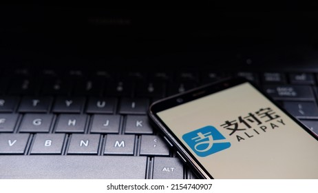 akarta, Indonesia - May 11, 2022: AliPay logo display on smartphone with keyboard background