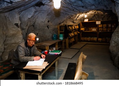 Akbakay, Kazakhstan - April 23 2012: Gold extraction mine interior. Miner works in underground office. 