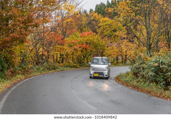 Akita,Tohoku,Japan - October\
22,2017 : The private car drive on autumn road  autumn in Akita,\
Tohoku\
,Japan.