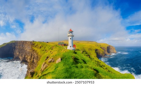 Akraberg Lighthouse, Suduroy Island, Faroe Islands, Denmark. Panoramic view of the rocks, field and the ocean. Lighthouse on top of the mountain. Photography for background, wallpaper, postcards. - Powered by Shutterstock