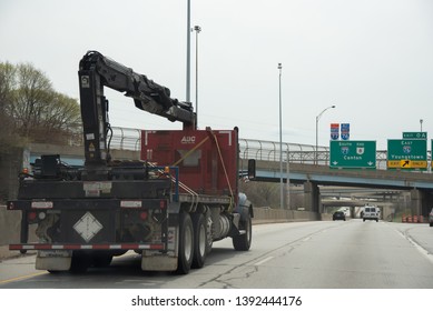 Akron, Ohio/USA - April 17 2019: Industrial Flat Bed Truck With Crane Driving On Highway Towards Canton Ohio.