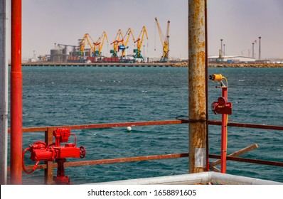 Aktau, Kazakhstan - May 19 2012: Caspian Sea, Gas Loading Terminal. Fire Sensor Right. Seaport On Back, Blurred.