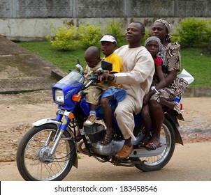 AKURE, NIGERIA, JULY 29, 2012: Five members of a nigerian family travelling by motorcycle,  in a Sunday of July 29, 2012 in the city of Akure,  in the south-west of Nigeria.