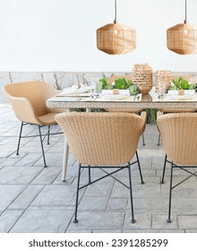 Al Fresco Dining Elegance, Woven Rattan Chairs and Matching Table Set Under Warm Rattan Pendant Lights, Outdoor Stone Tile Flooring, Accented with Greenery Centerpieces, White Tableware, Outdoor Home