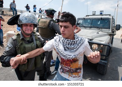 AL WALAJA, PALESTINIAN TERRITORY - MAY 10: Israeli Soldiers Arrest A Palestinian Youth During A Demonstration Against The Israeli Separation Wall In The West Bank Town Of Al-Walaja, May 10, 2013.