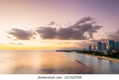 Ala Moana Beach Park and Magic Island, with Kakaako skyline of Honolulu  at sunset