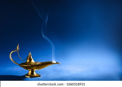 Aladdin magic lamp on blue background