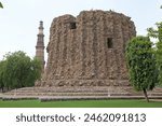 Alai Minar with Qutab Minar in the background in Delhi, India. It is a minaret, the construction was abandoned, that forms of the Qutab complex, a UNESCO World Heritage Site