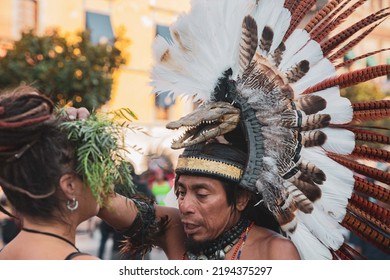 ALAJUELA, COSTA RICA - Jul 20, 2022: A Selective Focus Shot Of Aztec People Helping Each Other With Traditional Clothing On The Street