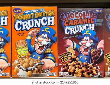 Alameda, CA - April 21, 2022: Grocery store shelf with boxes of Cap'n Crunch cereals. Peanut Butter and Chocolate Caramel Crunch flavors.