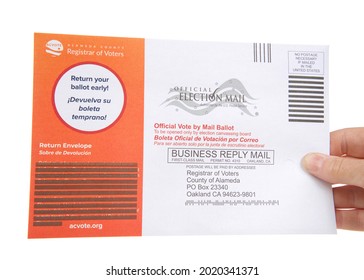 Alameda, CA - August 6, 2021: Caucasian Hand Holding Mail In Ballot, Isolated On White. Gubernatorial Recall Election Ballots Sent Out To All Registered Voters In California. 