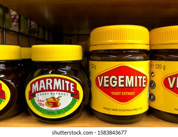 Alameda, CA - Dec 02, 2019: Grocery store shelf with Bottles of Vegemite and Marmite brand yeast extract. Both are brown pastes made from yeast extract, popular in Australia and throughout Britain.