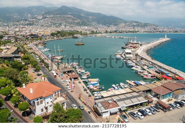 Alanya, Turkey – August 18, 2021. View over the\
harbour of Alanya, Turkey. View with residential buildings,\
commercial properties, boats and\
cars.