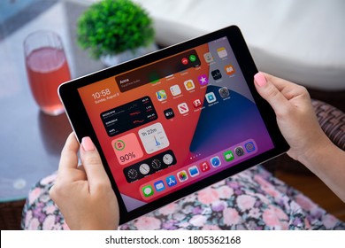 Alanya, Turkey - August 9, 2020: Woman hand holding iPad Pro IOS 14 with phone call widget on the home screen. iPad Pro was created and developed by the Apple inc.