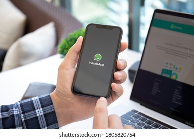 Alanya, Turkey - May 14, 2020: Man holding iPhone 11 with social networking service WhatsApp on the screen. iPhone and Macbook was created and developed by the Apple inc.
