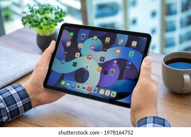 Alanya, Turkey - May 14, 2021: Man Hand Holding IPad Air IOS 14 With Widget On The Home Screen. IPad Was Created And Developed By The Apple Inc.