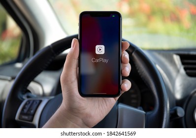 Alanya, Turkey - October 02, 2020: Woman hands holding Apple iPhone 11 with CarPlay in the screen phone Toyota car.