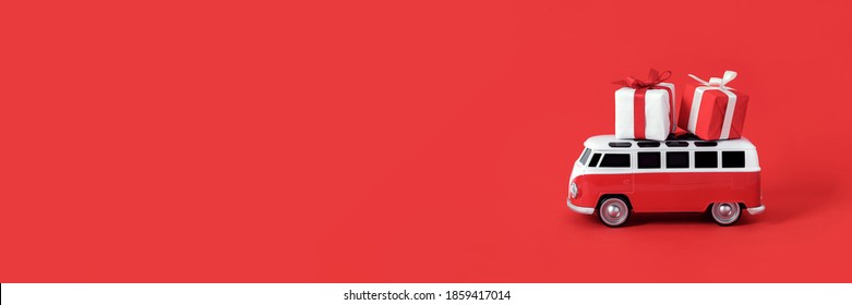 Alanya, Turkey, October 22, 2020: Christmas Gift Delivery Car Concept. Red Retro Bus Carries Two Gift Boxes. Front View Creative Abstract Composition Banner With Place For Text